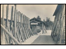 Kurume,  Foto-Ansichtskarte mit seltener Innenansicht des Lagers (Zaun, Baracken), undeutlicher Lagerstempel, roter Postleits